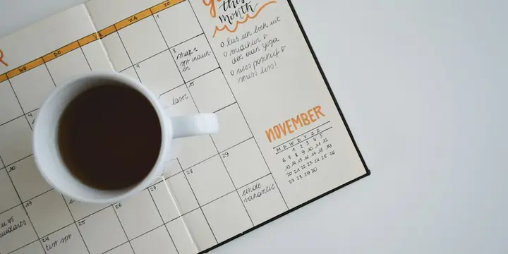 Planner calendar and a cup of coffee on a desk