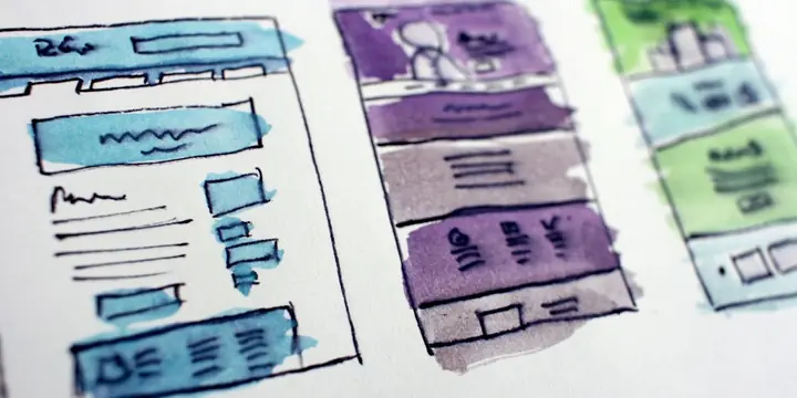 Colourful app wireframe sketches on paper